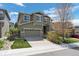 Two-story home featuring stone accents, a well-manicured lawn and a two-car garage at 5400 Heatherton Ln, Highlands Ranch, CO 80130