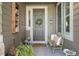 Inviting front entry features a cozy sitting area with stylish decor and a 'Welcome Home' doormat at 5400 Heatherton Ln, Highlands Ranch, CO 80130