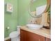 Charming half bathroom with decorative mirror, vessel sink, and tiled backsplash at 5400 Heatherton Ln, Highlands Ranch, CO 80130