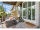 Relaxing covered patio with fire pit, hanging swing, and charming outdoor decor at 5400 Heatherton Ln, Highlands Ranch, CO 80130