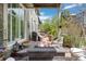 Spacious outdoor patio with a fire pit, grill, and hanging chairs, perfect for entertaining at 5400 Heatherton Ln, Highlands Ranch, CO 80130