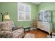Cozy sitting room with a floral armchair and ample natural light at 5400 Heatherton Ln, Highlands Ranch, CO 80130