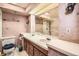 Basement bathroom featuring a double vanity and shower with glass doors at 798 Xenophon St, Lakewood, CO 80401