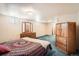 Basement bedroom featuring a bed, dressers, and blue carpets at 798 Xenophon St, Lakewood, CO 80401