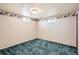 This bedroom features wallpaper with a palm tree border and teal carpet at 798 Xenophon St, Lakewood, CO 80401