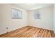 Bright bedroom featuring hardwood floors and dual windows for ample natural light at 798 Xenophon St, Lakewood, CO 80401