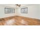 Bright bedroom with hardwood floors, two windows, a ceiling fan, and neutral walls at 798 Xenophon St, Lakewood, CO 80401