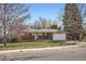 Charming single-story brick home with a well-manicured lawn and attached two-car garage on a sunny day at 798 Xenophon St, Lakewood, CO 80401