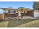 Charming covered front porch area, featuring brick accents and well-kept lawn with mature landscaping at 798 Xenophon St, Lakewood, CO 80401