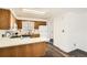 Functional kitchen featuring oak cabinets, white appliances, and ample countertop space for meal preparation at 798 Xenophon St, Lakewood, CO 80401