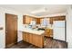 Efficient kitchen with oak cabinets, updated appliances, and a breakfast bar for casual dining at 798 Xenophon St, Lakewood, CO 80401