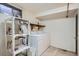 This laundry room features a washer and dryer and shelving units for storage at 798 Xenophon St, Lakewood, CO 80401