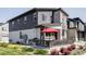 Grassy backyard and cozy patio with an outdoor grill, ideal for entertaining and enjoying the outdoors at 2023 S Upham Way, Denver, CO 80227
