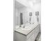 Bathroom featuring double sinks, large mirror, and a shower tub combination at 2023 S Upham Way, Denver, CO 80227