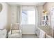 Bright Bedroom with a crib, armchair, and a window at 2023 S Upham Way, Denver, CO 80227