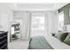 Serene main bedroom featuring soft natural light, a tray ceiling, and neutral, carpeted floors at 2023 S Upham Way, Denver, CO 80227