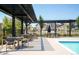 Outdoor patio with comfortable seating areas near the pool and modern townhomes at 2023 S Upham Way, Denver, CO 80227