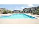 Sparkling community swimming pool with lounge chairs and nearby townhomes at 2023 S Upham Way, Denver, CO 80227