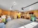 Spacious basement workshop with concrete floors, workbench, shelving, and overhead lighting at 26765 Bradley St, Conifer, CO 80433