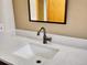 Modern bathroom vanity, featuring a light countertop, wood cabinet, and vintage-style faucet at 26765 Bradley St, Conifer, CO 80433