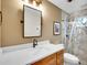 Modern bathroom with vanity, mirror, decorative lighting and tiled shower with glass doors at 26765 Bradley St, Conifer, CO 80433