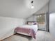Bedroom with a sloped ceiling, window, and cozy decor with a bed at 26765 Bradley St, Conifer, CO 80433
