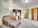 Comfortable bedroom with a chair, ottoman, shelving unit, and closet at 26765 Bradley St, Conifer, CO 80433
