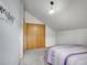 Cozy bedroom features neutral carpeting, attic ceiling, and double door closet storage at 26765 Bradley St, Conifer, CO 80433