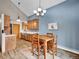 Bright dining area with wood table, cabinetry, and updated lighting fixtures at 26765 Bradley St, Conifer, CO 80433