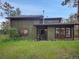 Charming two-story home with wood siding and well-maintained front yard surrounded by mature trees at 26765 Bradley St, Conifer, CO 80433