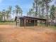 A detached two car garage with an attached covered parking area, on a large lot at 26765 Bradley St, Conifer, CO 80433