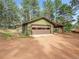 A detached two car garage with an attached covered parking area, with an easy access driveway at 26765 Bradley St, Conifer, CO 80433