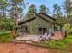 Charming single Gathering home with a relaxing back patio, mature trees, and lush greenery at 26765 Bradley St, Conifer, CO 80433