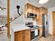Close up view of the kitchen, showcasing stainless appliances and light wood cabinets at 26765 Bradley St, Conifer, CO 80433