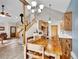 Bright, open kitchen with wood cabinets, modern lighting, and eat-in table space at 26765 Bradley St, Conifer, CO 80433