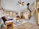Comfortable living room featuring wood-look floors, natural light, and staircase to the upper level at 26765 Bradley St, Conifer, CO 80433