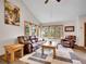 Inviting living room features vaulted ceilings, three windows, and cozy furniture at 26765 Bradley St, Conifer, CO 80433