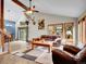 Spacious living room with vaulted ceilings, wood floors, and plenty of natural light from windows at 26765 Bradley St, Conifer, CO 80433