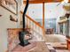Cozy living room with stone fireplace, open staircase, and beautiful wood-look floors throughout at 26765 Bradley St, Conifer, CO 80433