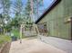 A relaxing swing set on the front porch with views of the pine forest around this property at 26765 Bradley St, Conifer, CO 80433