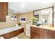 Elegant bathroom featuring a luxurious soaking tub, modern vanity, and stylish tile work at 4730 W Moncrieff Pl, Denver, CO 80212