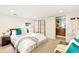 Bright bedroom with white walls, modern furnishings, and access to a stylish bathroom at 4730 W Moncrieff Pl, Denver, CO 80212