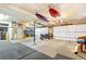 Spacious garage with ample storage, featuring a motorcycle and kayaks hanging from the ceiling at 4730 W Moncrieff Pl, Denver, CO 80212