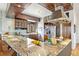 Modern kitchen featuring granite countertops, stainless steel appliances, and custom cabinetry at 4730 W Moncrieff Pl, Denver, CO 80212