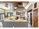 Modern kitchen featuring granite countertops, a large island, and stainless steel appliances at 4730 W Moncrieff Pl, Denver, CO 80212