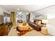 Inviting basement living area featuring a plush leather sofa, ottoman, and modern decor at 4730 W Moncrieff Pl, Denver, CO 80212