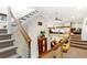 Open living area featuring stairs with metal cable railing and unique mezzanine-level bedroom space at 4730 W Moncrieff Pl, Denver, CO 80212
