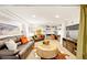 Cozy basement living area with comfortable seating, built-in shelving, and a stylish cowhide rug at 4730 W Moncrieff Pl, Denver, CO 80212
