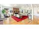 Comfortable living room with a brick fireplace, hardwood floors, and stylish furnishings at 4730 W Moncrieff Pl, Denver, CO 80212