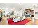Bright open-plan living room featuring hardwood floors, white sofas and a view into the kitchen at 4730 W Moncrieff Pl, Denver, CO 80212